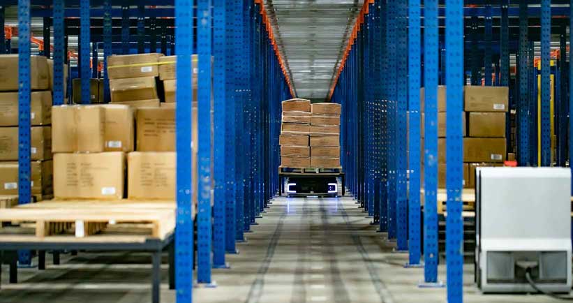 SHIP8 INC. automated storage and retrieval racking with Geek+ robot transporting pallet.